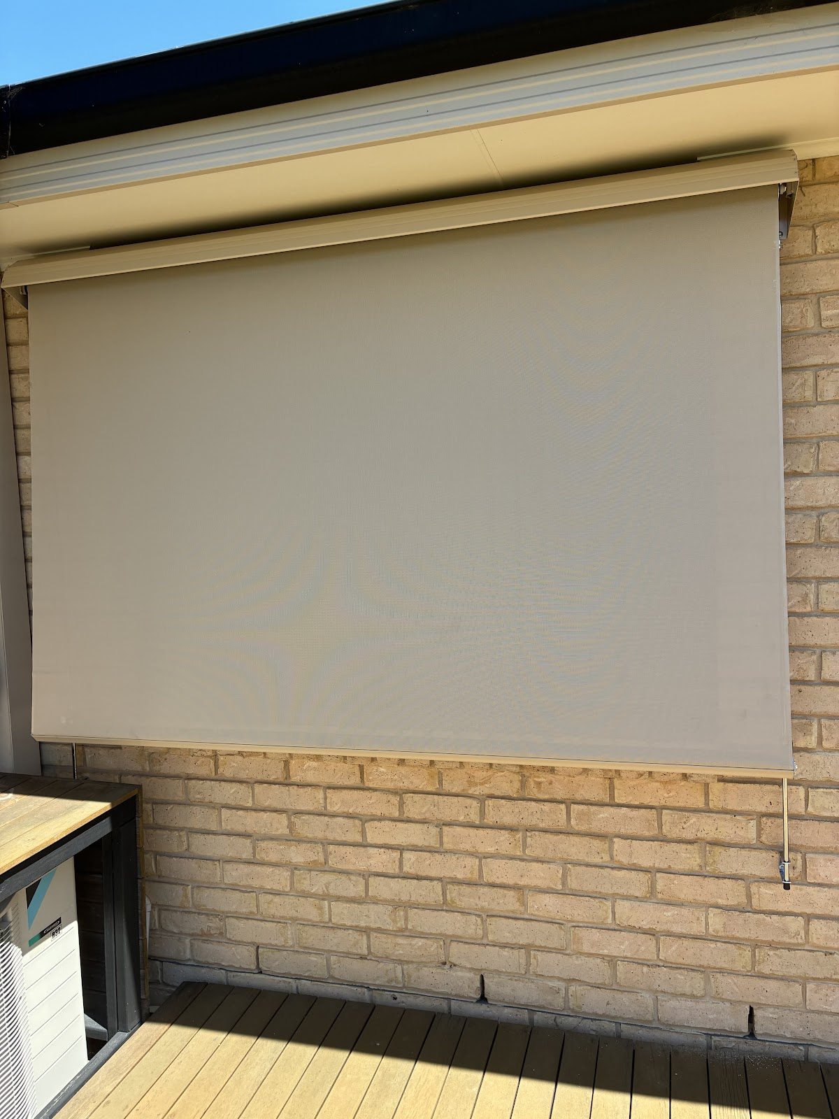 Straight drop awning over a window beside a deck