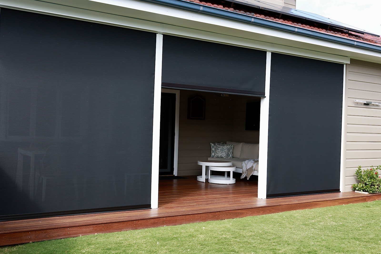 Zip screens on a renovated rear deck, one raised